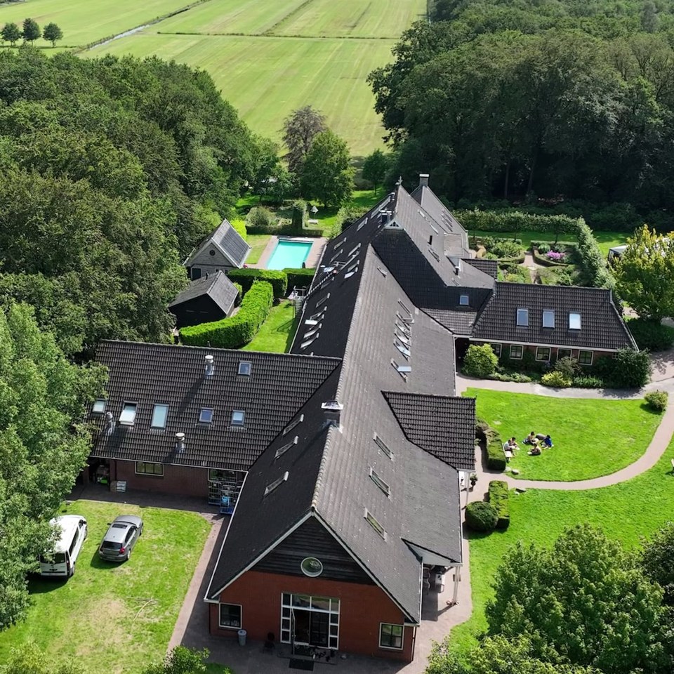 Aerial view of the full New Eden estate, its buildings and pool